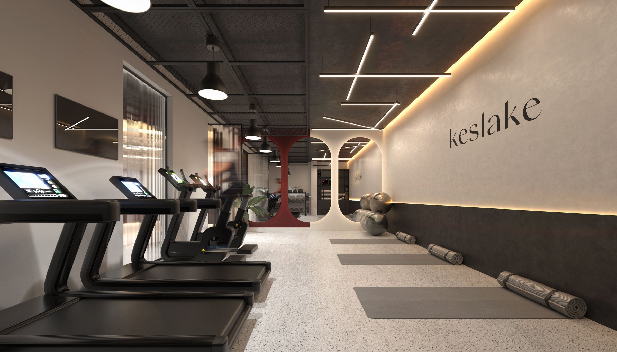 Keslake BTR branded gym with treadmills and dark feature wall — amenity interior by Ademchic