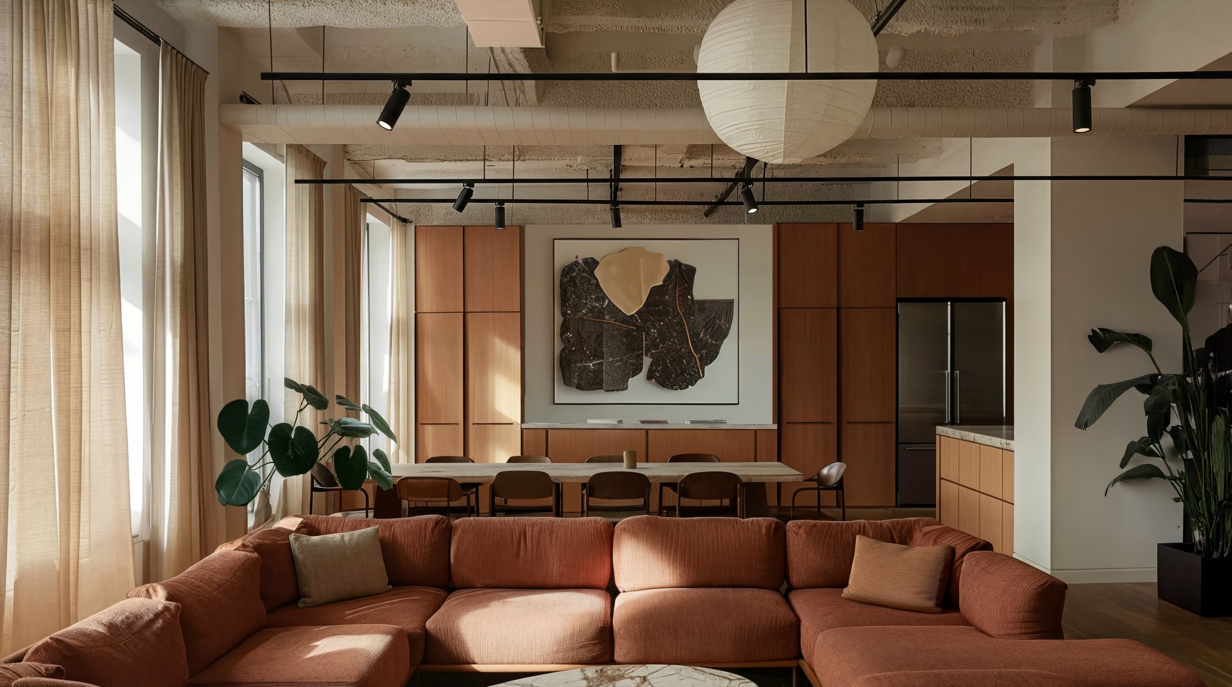 Co-working lounge with terracotta sofa, wood panelling and contemporary art — BTR amenity design by Ademchic