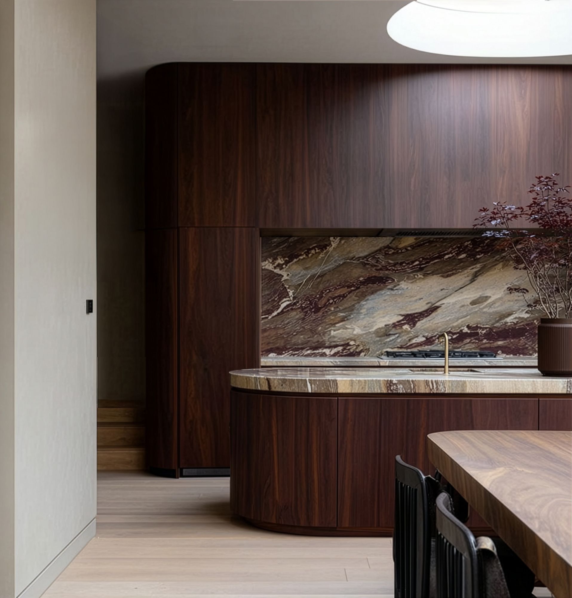 Bespoke dark walnut kitchen with curved island, marble splashback and brass detailing