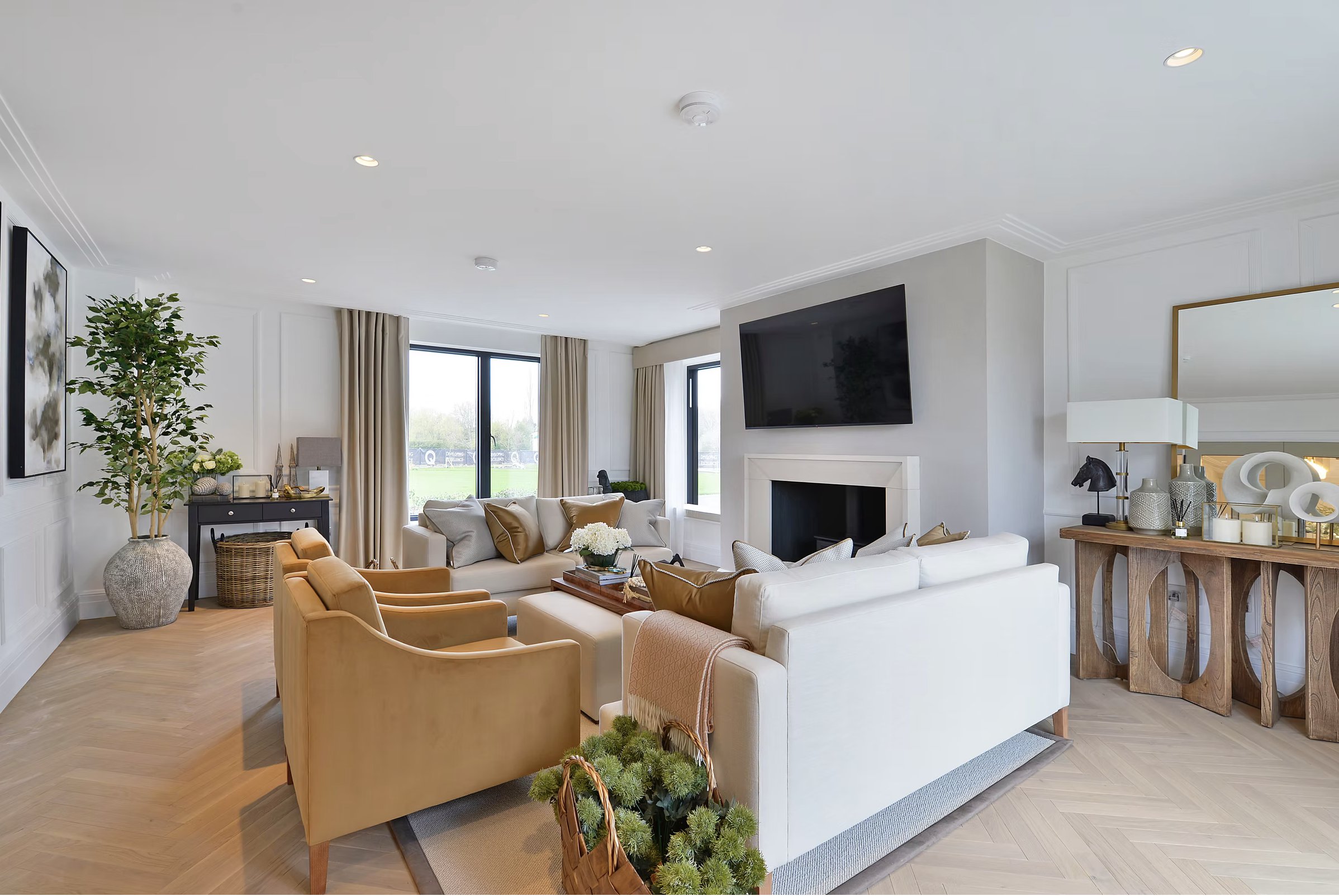 Alfold Gardens completed living room with fireplace, herringbone flooring and neutral palette — designed by Ademchic