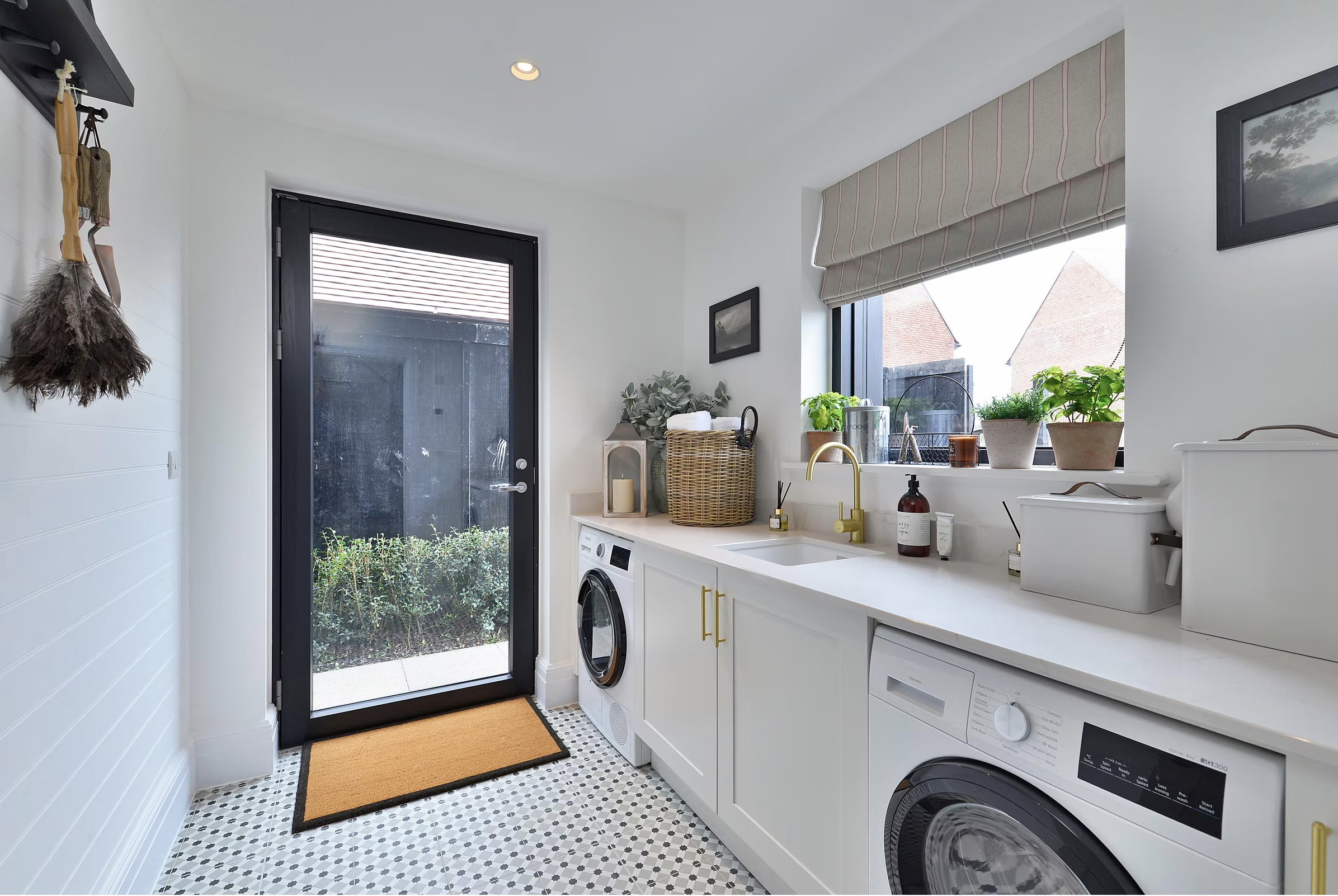 Alfold Gardens completed utility room with patterned floor tiles and garden access — designed by Ademchic