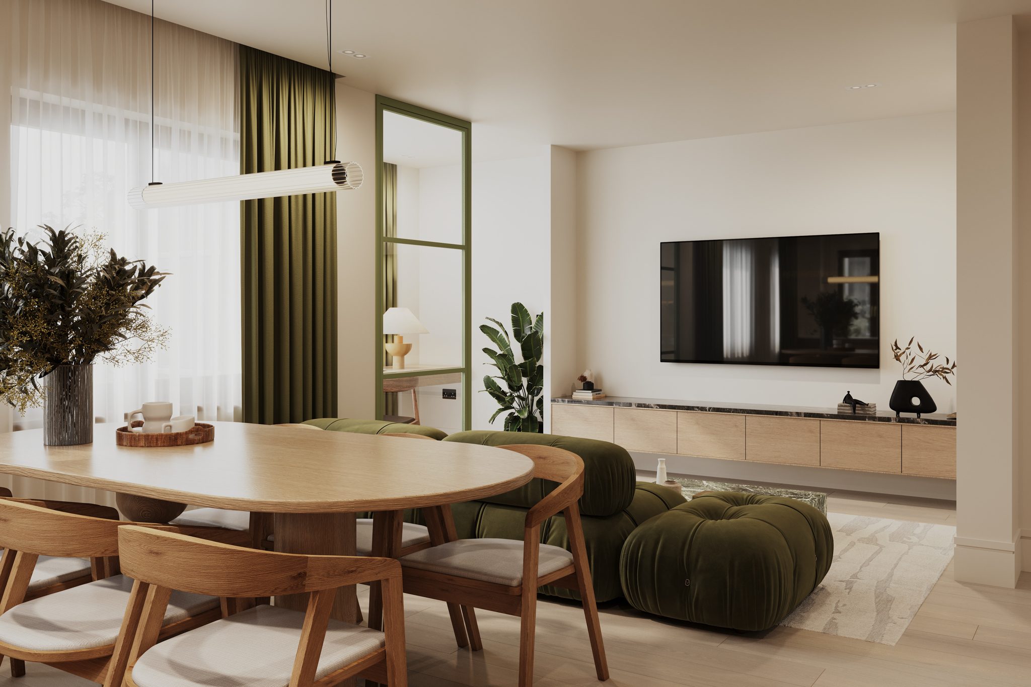 Angel Village dining area looking into living room with green sofa and media wall