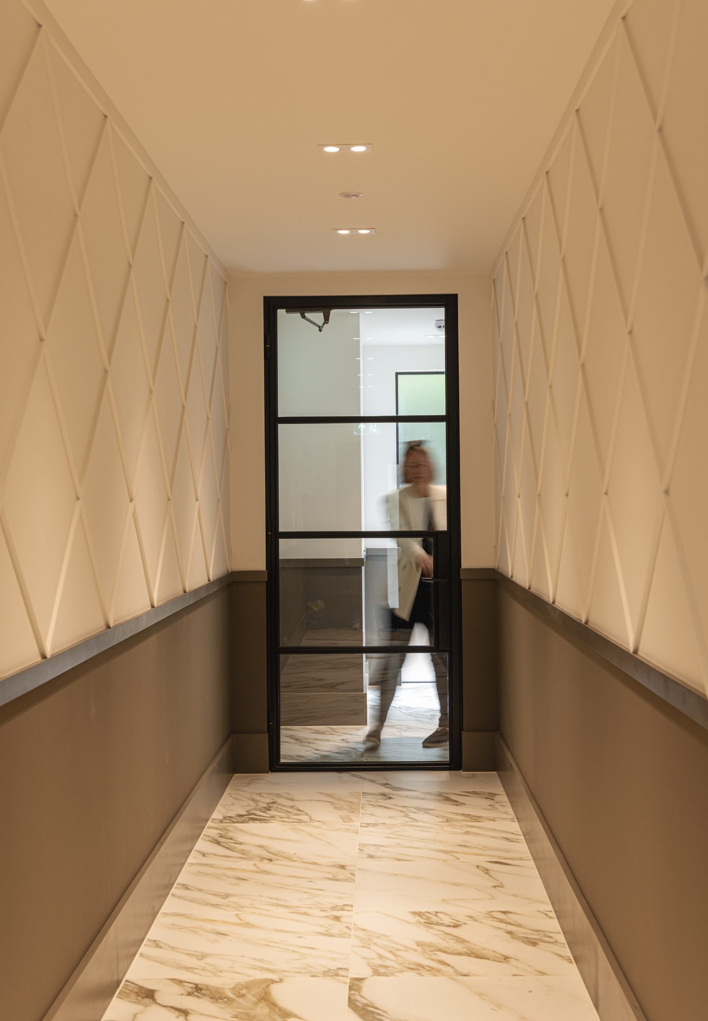 Ivy Gardens entrance hallway with marble flooring and crittal-style glazed door