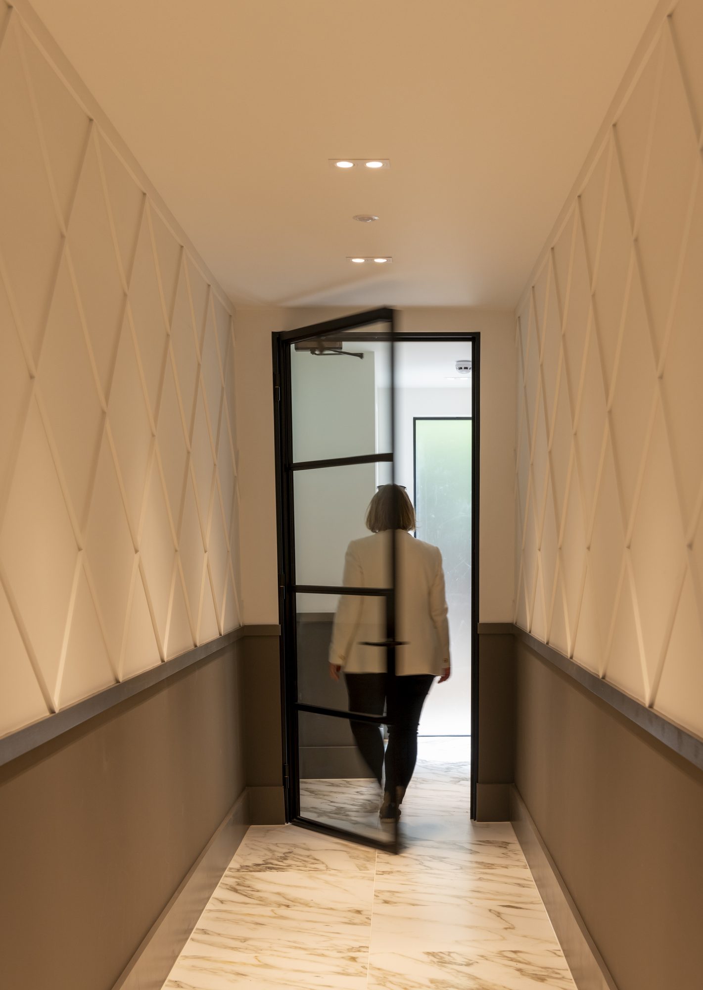 Ivy Gardens hallway — textured wall panelling and crittal glazed door