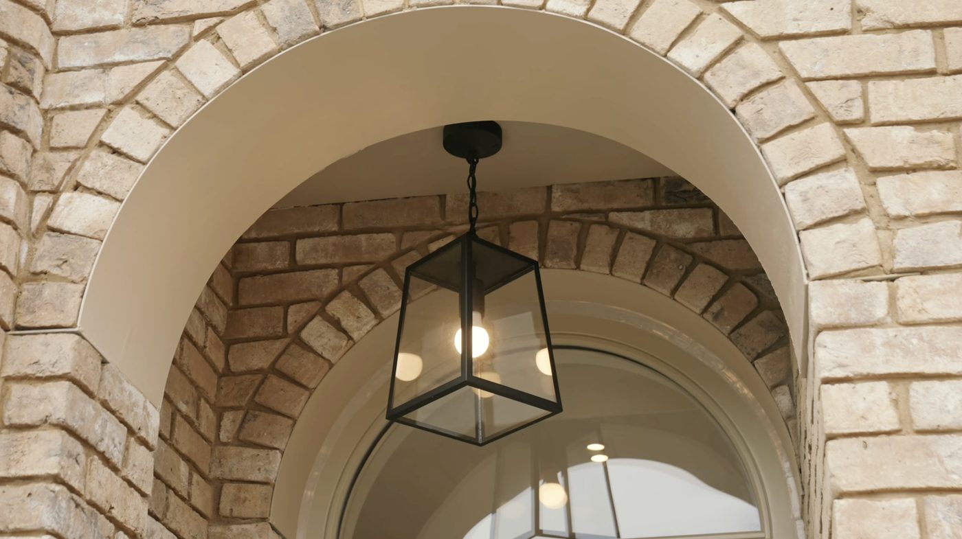Montpelier-Mews-exterior brick arch with pendant light — London mews development designed by Ademchic