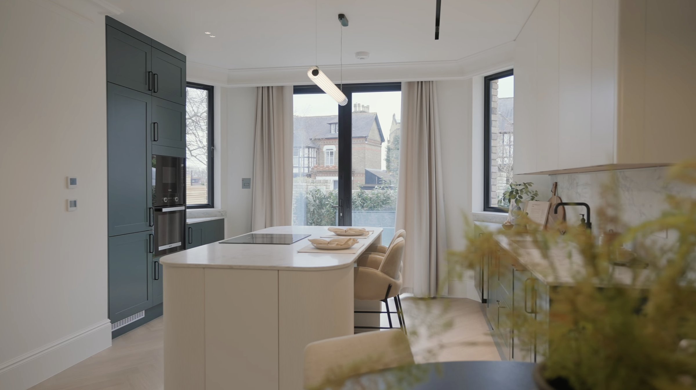 Montpelier-Mews-kitchen with green cabinetry, marble splashback and fluted island — designed by Ademchic